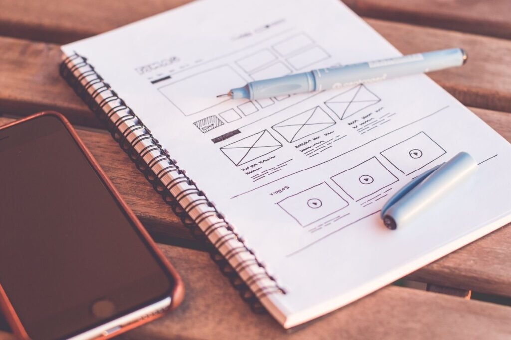 Interface wireframes sketched in a notebook